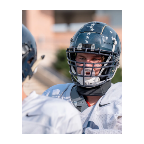 A football player in a helmet showcasing G8R SKIN, ready for action on the field with determination and focus.